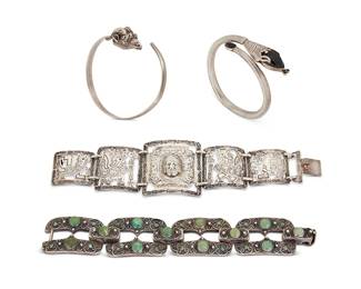 2206
A Group Of Bracelets
Mid/late 20th century
Three marked for maker and for silver
Four works comprising an Aztec-style chased 900 silver metal link bracelet, a coin silver link bracelet with filigree overlay and set green stone cabochons, as well as a Mexican sterling silver and set onyx crossover bangle, and a silver-toned metal crossover bangle with a ram's head terminal, 4 pieces
Link bracelets: 7.5" L x 1.875" H and 7" L x 1.25" H; bangles: 7.75" inner C and 7.25" inner C
186.0 grams gross
Estimate: $300 - $500