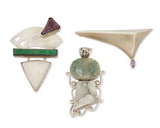 2049
A Group Of Modernist Silver And Gemstone Jewelry
Late 20th/21st century
Each marked for sterling; one marked for maker and for stones
Three works comprising a Karen and Sean Joyce "Sailing the Orient" sterling silver and gemstone brooch with Russian garnet and white drusy quartz, as well as a sterling silver and stacked set green drusy stone pendant, and a sculptural sterling silver modernist brooch with set gemstone, 3 pieces
Brooches: 3" H x 2" W and 1.5" H x 3" W; pendant: 2.75" H x 1.5" W
82.5 grams gross
Estimate: $300 - $500