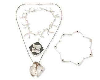 2012
A Group Of Modernist Jewelry
Mid/late 20th century
Three marked for maker and for sterling
Four works comprising a large sterling silver and set onyx/black stone pendant with inset/intarsia "picture" jasper, a Hans Hansen Danish sterling silver necklace with narrow V-shaped links and stone inlay accents, a Jens Asby Danish sterling silver pendant with three concave triangular segments on an associated sterling silver chain, and an unmarked silver necklace with dancing figure links, 5 pieces
Necklaces: 16" L and 14.5" L; pendants: 3" H x 2.5" W; and 2.375" H x 2.25" W; chain: 30" L
151.2 grams gross
Estimate: $800 - $1,200