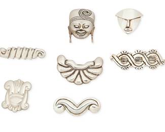 2101
A Group Of Mexican Silver Brooches Including Hector Aguilar
Seven works:

Hector Aguilar (1905-1986)
Circa 1940-1945 and 1948-1962; Taxco, Mexico
Each stamped: HA [conjoined] / Taxco; further variously stamped: 940 / 990 / Made in Mexico / Sterling / Mexico / [Eagle 9] /
Six sterling silver brooches in various figural, scrollwork, and geometric motifs including a "three domes" pin and an "abstract face" pin, 6 pieces
Largest: 1.125" H x 3" W; smallest: 1.5" H x 1.125' W

Ana Maria Nuñez Brilanti (c. 1910-1999)
Circa 1958; Taxco, Mexico
Stamped: Victoria / Taxco / Mexico / Sterling / [Eagle 12] / Cony / 662
A Victoria/Cony sterling silver mask pendant/brooch with dangle earrings
2" H x 1.625" W

7 pieces total
132.9 grams
Estimate: $300 - $500