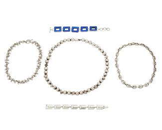2226
A Group Of Sterling Silver Jewelry
Mid/late 20th century
Two marked for maker and for country; four marked for sterling; one marked: 900
Five works comprising a delicate vintage Janiyé Japan sterling silver herringbone link bracelet and a sterling silver rectangular link bracelet with inset textured blue glass, as well as a chunky Mexican sterling silver bead necklace, with alternating ball and cube beads, and two vintage silver chain link collar necklaces, one an anchor chain and one a silver ball "jacks" chain, 5 pieces
Bracelets: 8" L x 0.75" H and 7.125" L x 0.5" H; necklaces: 23.75" L; 17.5" L ; 17.25" L
319.9 grams gross
Estimate: $400 - $600