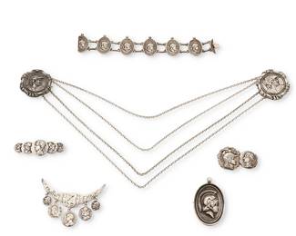 2136
A Group Of Ancient Coin-Style Silver Jewelry
Late 19th/early 20th century
Five marked for sterling; three variously marked for makers George W. Shiebler & Co. (1876–1907) and Frank M. Whiting & Co. (active 1878-1940)
A group of ancient coin-motif jewelry including three sterling silver brooches, one by Schiebler and two brooches by Whiting including one with inscription: "Taurom Enium", together with an unmarked antique-style link bracelet with Greco/Roman warrior head motif and a large matching pendant/brooch, as well as a pair of chatelaine brooches with possibly Alexander the Great head motifs, 6 pieces
Largest brooch: 2.125" H x 3" W; smallest: 1.125" H x 1.875" W; bracelet: 7.125" L x 1.125" H; pendant: 2.125" H x 1.5" W; chatelaine: each: 1.625" Dia. x 12.5" W
147.2 grams gross
Estimate: $600 - $800