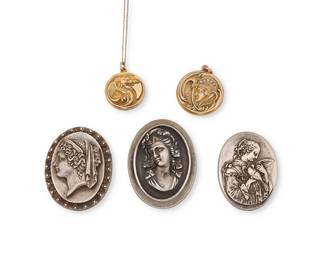 2137
A Mixed Group Of Figurative Jewelry
20th century
Three marked for Henryk Winograd (Polish/American, 1917-2008); further variously marked: 925 / 999
Five works comprising three sterling silver cameo style portrait brooch/pendants by Henryk Winograd, together with two gold-filled monogrammed repoussé lockets, one a dragon motif on a fine chain, and one an Art Nouveau-style profile with set stones, 5 pieces
Pendants: 2.125" H; 2" H; 1.875" H; lockets: 1.375" H and 1.25" H; chain: 18" L
98.2 grams gross
Estimate: $700 - $1,000