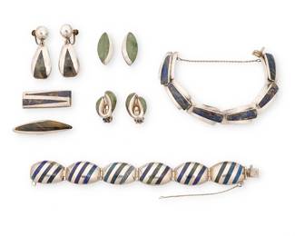 2230
A Group Of Enrique Ledesma Mexican Silver And Stone Inlay Jewelry
Enrique Ledesma (d. 1979)
Circa 1955-1979; Taxco, Mexico
Each variously stamped: Ledesma / Taxco / Hecho in Mexico / 925 / [Eagle 3] / [Eagle 60] / [design numbers: 212, 227, 232, 235, 284, 322]
Seven works in sterling silver comprising two link bracelets with blue and green azurmalachite stone inlay to each link, as well as three pairs of abstract earrings each with stone inlay, and a tie clip with set tiger's eye type stone, and a money clip with blue stone inlay, 10 pieces
Largest bracelet: 6.75" L x 0.75" H; smallest: 6.5" L x 0.625" H; largest earring: each: 1.75" H; tie pin: 0.5" H x 2" W; money clip: 0.625" H x 1.5" W
132.2 grams gross
Estimate: $400 - $600