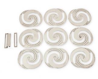 2065
A Group Of Hector Aguilar Mexican Silver Conchos
Hector Aguilar (1905-1986)
Circa 1943-1948; Taxco, Mexico
Each concho unmarked; buckle: HA [conjoined] / Made in Mexico / Sterling
Nine silver belt conchos, each formed from incised openwork discs with a swirling spiral design, as well as an associated two-piece sterling silver belt clasp, 11 pieces
Each concho: 2.375" H x 2.75" W approximately; buckle: 1.75" H
168.3 grams
Estimate: $200 - $400