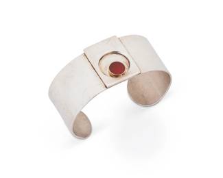 2028
A Vintage Pierre Cardin Sterling Silver And 14K Gold Cuff Bracelet
Circa 1960s
Stamped: Pierre Cardin / Paris - New York / Sterling Silver - Argent / 14K
A modernist silver cuff with central applied geometric panel with 14K gold bezel-set orange stone
6.5" total inner C x 1.125" H, with a 1" gap
46.5 grams gross
Estimate: $500 - $700