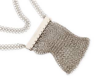 2098
A Vintage Paco Rabanne Chain Mail Purse/Necklace
Late 20th century
Marked to frame exterior: Paco Rabanne
A small shoulder bag or necklace of silver-toned metal round links with a magnetic frame clasp and narow double chain mail strap with fixed black leather strap and buckle closure
6" H x 3.5" W; strap drop: 13" (buckled)
Estimate: $200 - $300
