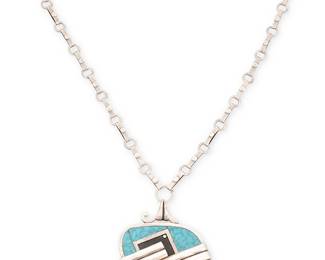 2014
A Victor Jaimez Mexican Silver Inlay Pendant Necklace
Victor Jaimez (b. 20th century)
Mid-20th century, Taxco. Mexico
Stamped to stone: VJC / Taxco / 925 / Emma / Hecho en Mex
A Victor Jaimez for Emma Melendez sterling silver reversible pendant with blue stone inlay and black enamel, suspended from a bar and loop silver chain
19" L x 3" H
43.1 grams gross
Estimate: $200 - $400