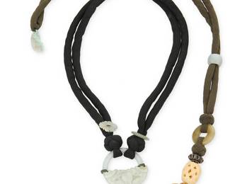 2041
A Group Of Pat Tseng Jewelry
Late 20th/21st century
Unmarked
Two vintage carved jade necklaces comprising a carved pale green jade ring pendant with a jade disc and carved bead on a knotted double-strand black silk padded cord with enamel butterfly clasp, as well as a long pendant necklace of multiple stacked carved jade auspicious characters including a moth, and a frog, all mounted to an olive silk padded cord with jade slider beads and a carved jade fish
Larger: 38" L x 8" H; smaller: 22" L x 1.875" H
Estimate: $600 - $800