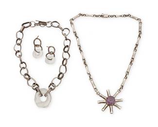 2119
A Group Of Modernist Silver Jewelry
Mid/late 20th century
One marked for maker and for sterling
Three works comprising a Mexican sterling silver chunky link collar necklace with purple set stone starburst pendant as well as a silver and art glass collar necklace with hand-hammered silver freeform chain links featuring a central art glass link, together with a pair of matching earrings, 4 pieces
Necklaces: 18.75" L x 1.625" H and 16.5" L x1.125" H; each earring: 1.5" H
136.5 grams gross
Estimate: $300 - $500