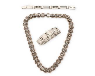 2075
A Group Of Hector Aguilar Mexican Silver Jewelry
Hector Aguilar (1905-1986)
Circa 1940-1945; Taxco, Mexico
Each stamped: HA [conjoined]; further variously stamped 940 / Taxco / Made in Mexico / Sterling
Three works in sterling silver comprising a chunky necklace of incised clipped "coin" links with raised hook elements, as well as a "Lyre" link bracelet with wave form overlay and stacked silver balls, and a "slim bands and beads" link bracelet, 3 pieces
Necklace: 21.375" L x 0.625" H; bracelets: larger: 7.5" L x 0.625" H; smaller: 7" L x 0.375" H
227.7 grams
Estimate: $700 - $900