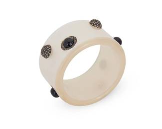 2023
A Vintage Judith Jack Bangle Bracelet
Late 20th century
Marked for maker and sterling to roundels verso; faintly visible below resin
An opaque pearlized acrylic resin/Lucite bangle with applied sterling silver roundels with onyx and marcasite accents
7.75" inner C x 1.75" H
Estimate: $200 - $300