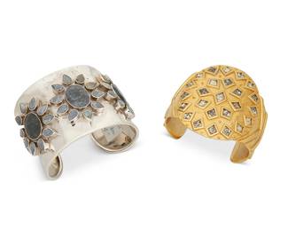 2153
Two Statement Cuff Bracelets
Late 20th/21st century
Each marked for maker; one marked for sterling
Two works comprising a Kara Ross cuff bracelet in gold plated metal with diamond-shaped snakeskin inserts, together with a Fadi India sterling silver cuff bracelet with cluster set sapphires of various colors in floral motifs
Larger: 7.25" inner C x 2" H, with a 1" gap; smaller: 6.5" total inner C x 2.375" H, with a 1.375" gap
175.3 grams gross
Estimate: $200 - $400