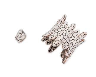 2061
A Set Of John Hardy Sterling Silver Kali Jewelry
Late 19th/21st century
Each marked: JH [conjoined] / 925
Comprising a Kali flexible oversized cuff bangle with pebble "river stone" motifs and a similar design Kali silver twist ring, 2 pieces
Cuff: 6.5" inner C x 2.5" H, with a 1" maximum gap; Ring: size: 8
206.5 grams
Estimate: $600 - $800