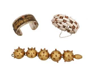 2193
A Group Of Bracelets
Mid/late 20th century
Two marked for maker; one marked for sterling
Three works comprising a Mexican sterling silver and copper link bracelet with three rows of alternating brick links and copper balls, as well as a Maya Mexico mixed metal brass "sputnik" Harmon-style link bracelet, and an upcycled silver metal cuff with an old brass machine service tag applied to band, 3 pieces
Largest: 7.75" L x 1.25" H; smallest: 7.25" L x 0.875" H
230.5 grams gross
Estimate: $200 - $400
