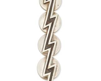 2181
A Vintage Zina Sterling Silver Brooch
Late 20th century
Stamped verso: Zina / 925
A narrow pin designed with conjoined circles and a zigzag lightning bolt
0.625" H x 3.375" W
21.1 grams
Estimate: $150 - $250