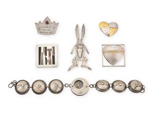 2198
A Group Of Silver Jewelry
Late 20th/21st century
Five marked for maker; four marked for metal
Six works comprising an oxidized silver disc link bracelet with mixed metal overlay motifs, as well as five pictorial pins/brooches in various designs including a Pat Flynn sterling silver and 18k gold heart brooch, an Ahlers sterling silver heart pin, a sterling silver rabbit brooch with double-pin prong closure, a Carly Wright geometric brooch, and a signed "Queens Never Bargain" crown pin, 6 pieces
Bracelet: 8" L x 1" H; brooches: largest: 3" H x 1.375" W; smallest: 1" H x 1.125" W
75.7 grams gross
Estimate: $500 - $700