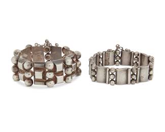2168
Two Hector Aguilar Mexican Silver Bracelets
Hector Aguilar (1905-1986)
Circa 1940-1945; Taxco, Mexico
Each stamped: HA [conjoined]; further variously marked: 940 / Taxco / Made in Mexico / Sterling
Comprising a chunky sterling silver link bracelet with pyramid and stacked silver ball links, and a "book and three beads" narrow link bracelet with scrolled links, 2 pieces
Each bracelet: 7.25" L; larger: 1.125" H; smaller: 0.75" H
160.1 grams
Estimate: $800 - $1,200