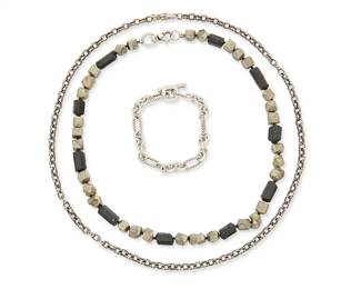 2150
A Group Of Sterling Silver And Stone Bead Jewelry
Late 20th/21st century
Two marked for maker and for sterling; one marked for 18K gold
Three works comprising a sterling silver Chrome Hearts 1999 chain link necklace, a David Yurman sterling silver and 18K gold chain link bracelet, and a chunky bead collar necklace with black tourmaline and pyrite, 3 pieces
Necklaces: 22" L and 18.5" L; bracelet: 7.25" L
114.7 grams gross
Estimate: $500 - $700