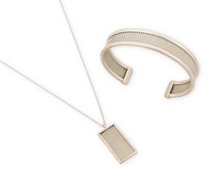 2001
A Set Of Tiffany & Co. Sterling Silver Jewelry
Late 20th/21st century
Each stamped: © / T & Co. / 925
Comprising a delicate silver mesh pendant necklace together with a matching mesh cuff bracelet, 2 pieces
Necklace: 24" L x 1.25" H; cuff: 7.5" inner C x 0.625" H
29.5 grams
Estimate: $500 - $700