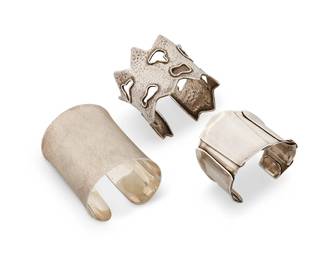 2071
A Group Of Sterling Silver Modernist Cuff Bracelets
Late 20th/21st century
One marked for maker; one marked for sterling
Three works comprising a Wolf Dosch sterling silver tapered cuff with fold details, a sand-etched sterling silver gauntlet cuff, and a hand hammered sterling silver cuff with zigzag edges and abstract openwork details, 3 pieces
Cuffs: 7" inner C x 2.5" H; 6.75" inner C x 3" H; 6.5" inner C x 2.25" W
226.8 grams gross
Estimate: $400 - $600