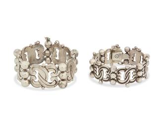 2091
Two Hector Aguilar Mexican Silver Link Bracelets
Hector Aguilar (1905-1986)
Circa 1940-1945, 1943-1948; Taxco, Mexico
Each stamped: HA [conjoined]; further variously stamped: Taxco / 940 / Sterling / Made in Mexico
Two chunky sterling silver bracelets each with curvilinear interlaced X-form links alternating with stacked silver balls, 2 pieces
Larger: 7" L x 1.125" H; smaller: 6.5" L x 1" H
121.7 grams
Estimate: $700 - $900