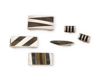 2006
A Group Of Enrique Ledesma Mexican Silver And Stone Inlay Jewelry
Enrique Ledesma (d. 1979)
Circa 1955-1979; Taxco, Mexico
Each stamped for Ledesma, sterling and Mexico; further variously marked: Taxco / [Eagle 3] [Eagle 60] / Plateria Cortes / [design number 235, 250, 271]
Five works in sterling silver and stone inlay including three belt buckles with inlay including obsidian and tiger's eye, as well as a tie clip and a pair of cufflinks, 6 pieces
Largest buckle: 1.125" H x 2.125" W; smallest: 1" H x 2" W; tie pin: 0.5" H x 2" W; each cuff link: 0.875" H
120.9 grams gross
Estimate: $200 - $400