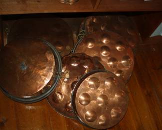 There is a large selection of vintage copper pans