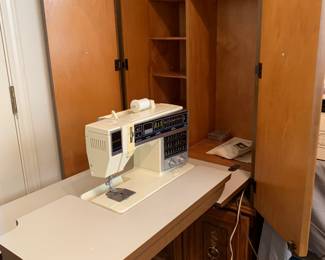 Singer sewing machine with cabinet.  All in one