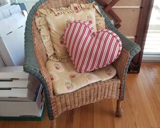 Wicker arm chair with floral cushions