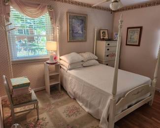 This bed has a canopy and two matching dressers