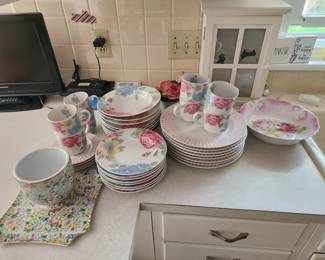 Rose pattern ceramic dinnerware setting for eight.