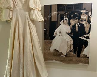 Dress: Unadorned Silk Taffeta Wedding Dress from 1958 ). It has a bateau neck,double flounced sleeves that come to the elbow. Front of dress comes to the top the shoe, while the back is longer with covered buttons and small bow.  Canvas picture is the bride and groom