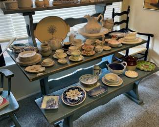 Dining table with two benches. Assorted dishes/china