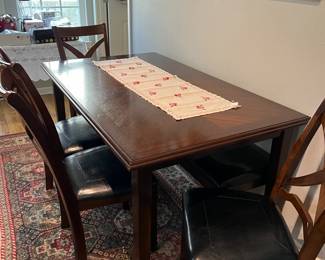 Dark Brown dining room table with 4 chairs and a bench