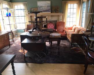 Variety of tables, chairs and art.