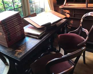 Old desk, four Victorian chairs, vintage Popular Mechanics hardcover books.