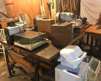 Industrial table, vintage stereo player, projectors and typewriters.