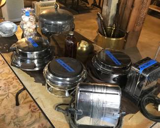 Vintage waffle makers, two toasters, food warmer, and jar of seashells.