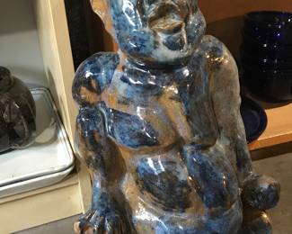 Ceramic Buddha-like statue.