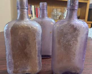 old whiskey bottles about 12 of them