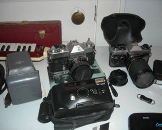 Collection of cameras and accessories.