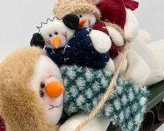 snowman family on sled