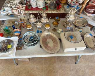 An assortment of silver plated and silver on copper items. Beautiful, hand crafted ceramic, straining, fruit bowl with matching dip cup and saucer. An assortment of glass wear and collector plates. 