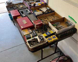 Several tables of tools, some brand new