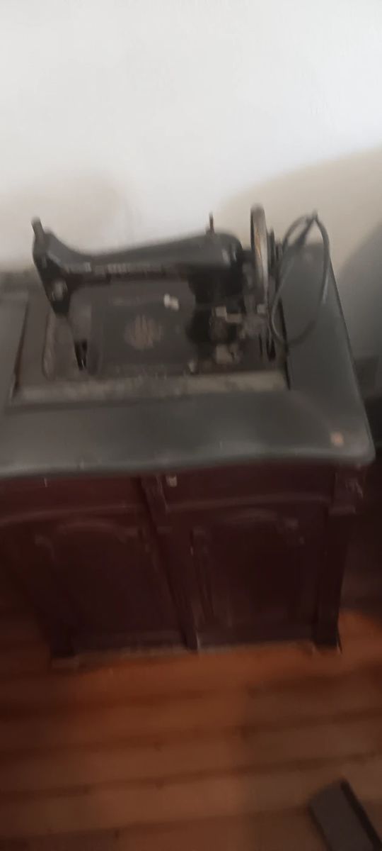 Antique sewing machine in Antique cabinet