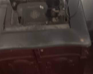 Antique sewing machine in Antique cabinet