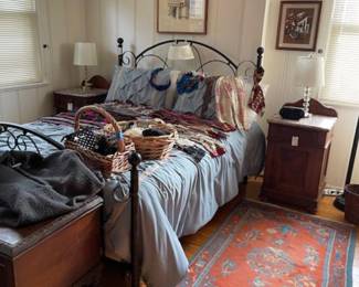 Full size bed loaded with women's accessories