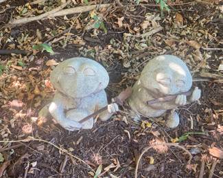 Cute concrete frog musicians. 