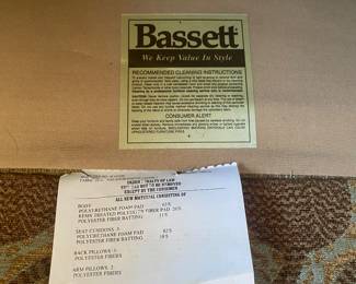 Bassett label on the curved full sized upholstered sofa. 